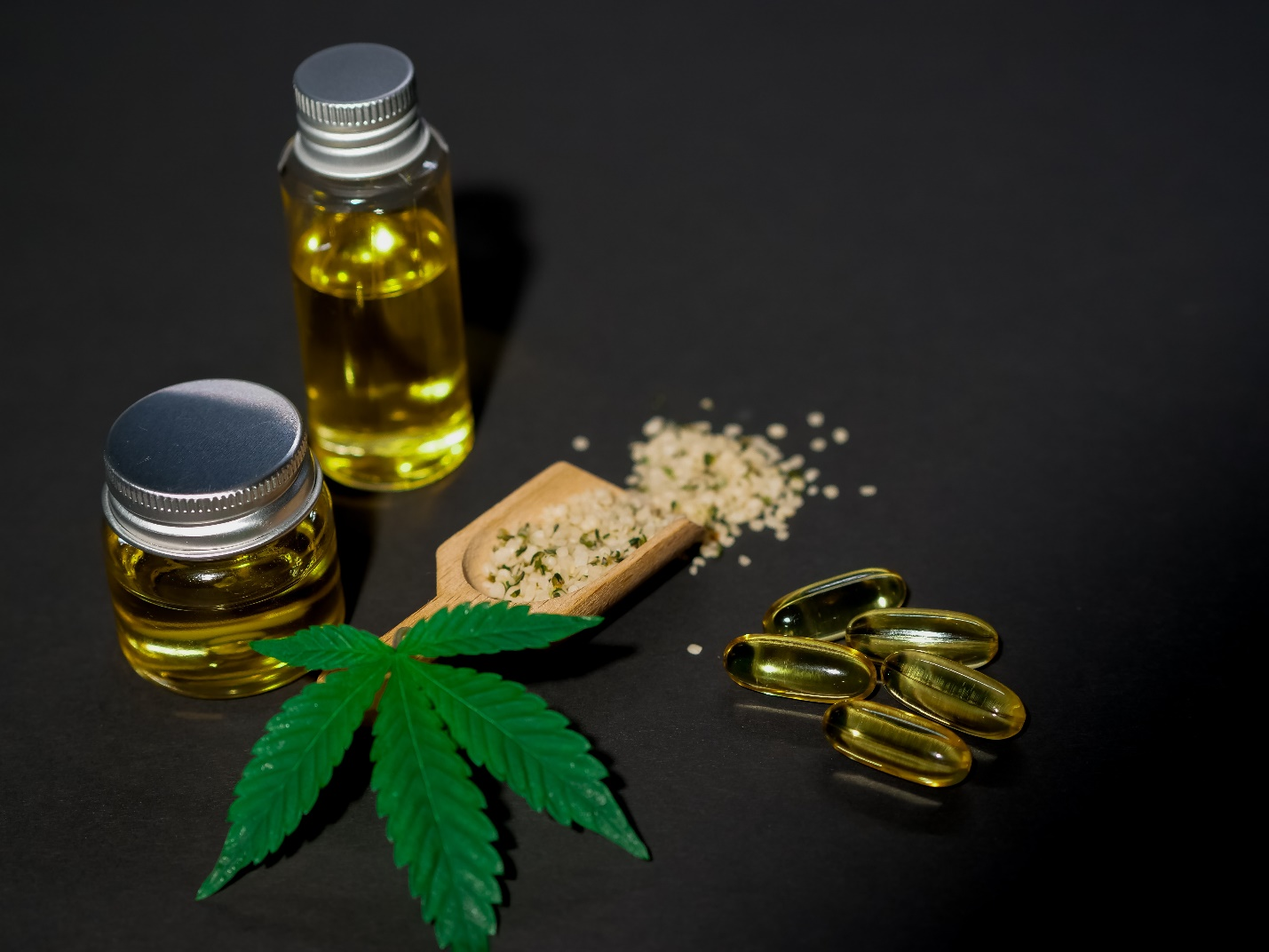 An array of CBD products pictured with a marijuana leaf