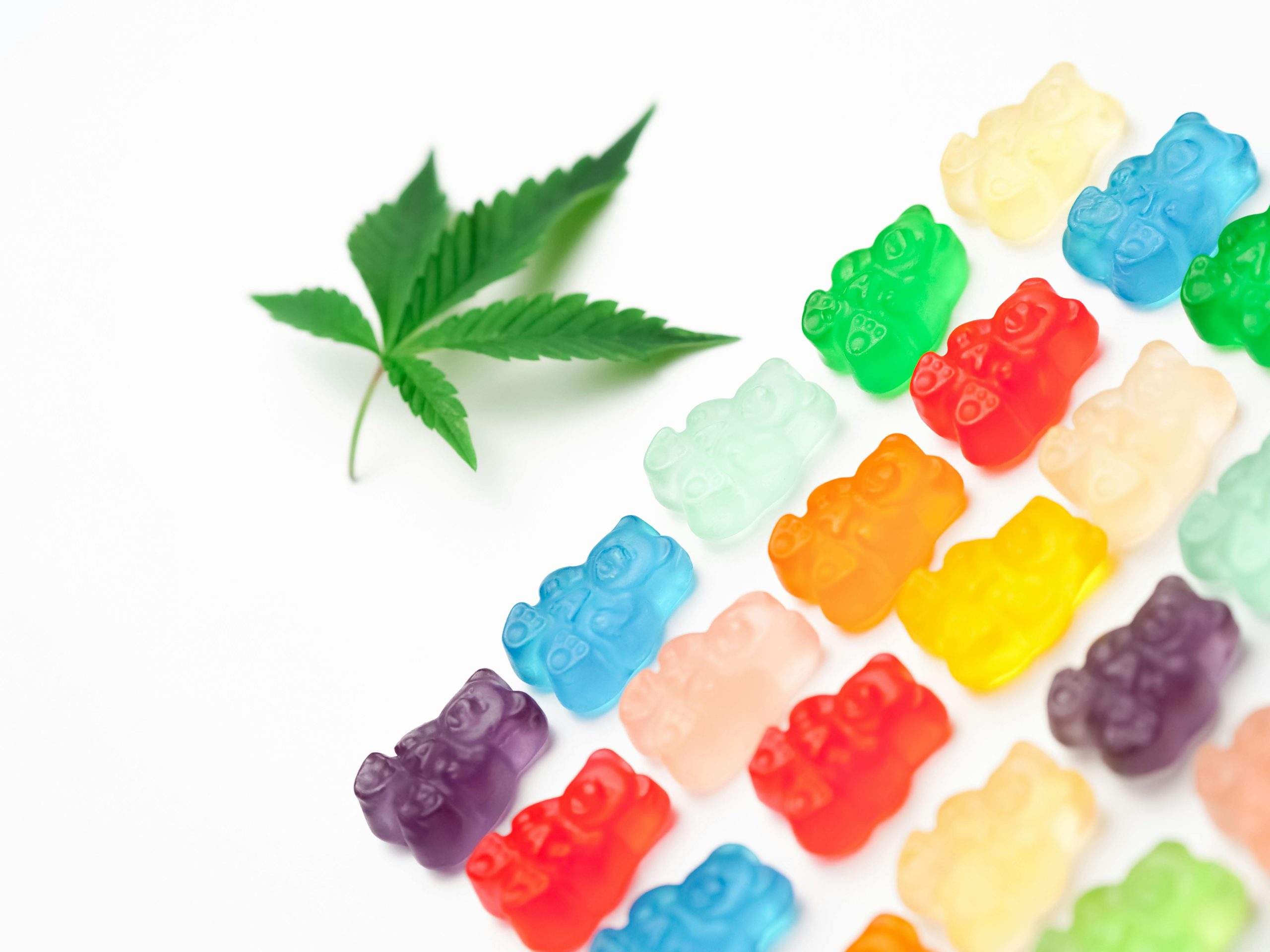 colored CBD gummies lined on a white surface